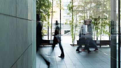 Time-lapse photo of people walking in a building