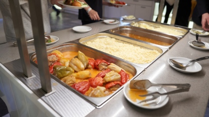 A buffet with Russian dishes, which features traditional dishes in metal containers. 
