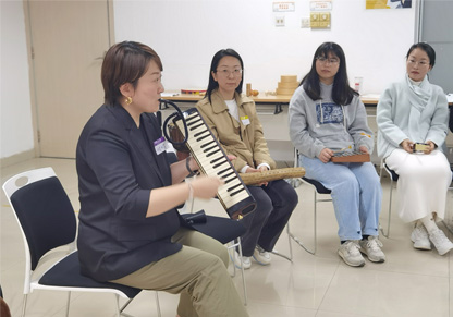 A group of women in a music workshop. 