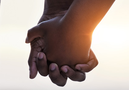 Two people holding hands