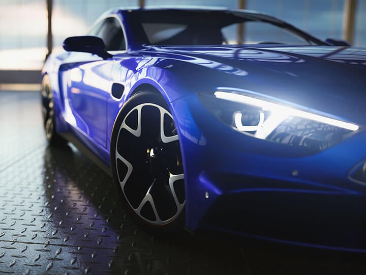 royal blue sports car in showroom with headlights on