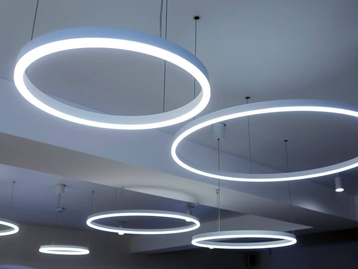 Round modern white LED lamps suspended from a ceiling