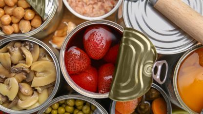 A variety of canned food items displayed, showcasing different types and labels in an organized arrangement.